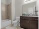 Clean bathroom with a shower/tub combo and dark vanity at 212 Golden Sands Cir, Davenport, FL 33837
