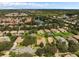 Wide aerial view of a neighborhood with houses, streets, and a lake at 11045 Belmere Isles Ct, Windermere, FL 34786