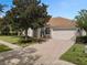 House exterior with two-car garage and landscaping at 11045 Belmere Isles Ct, Windermere, FL 34786