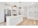 Modern kitchen with white shaker cabinets, quartz countertops and a large island at 131 E Grant, Orlando, FL 32806