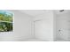 Bedroom with sliding closet doors and a window overlooking trees at 131 E Grant, Orlando, FL 32806