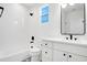 Modern bathroom with white cabinets, quartz countertop, and black matte fixtures at 131 E Grant, Orlando, FL 32806