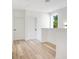Bright hallway with light wood flooring and two doors at 131 E Grant, Orlando, FL 32806