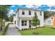 Modern two-story house with a white exterior, landscaped lawn, and paver driveway at 131 E Grant, Orlando, FL 32806