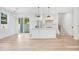 Open concept kitchen with white cabinets, island, and stainless steel appliances at 131 E Grant, Orlando, FL 32806