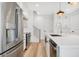 Modern kitchen with stainless steel appliances and white cabinetry at 131 E Grant, Orlando, FL 32806