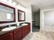 Double vanity bathroom with dark wood cabinets and granite countertops at 14501 Grove Resort Ave # 1507, Winter Garden, FL 34787