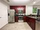 Modern kitchen with dark wood cabinets and stainless steel appliances at 14501 Grove Resort Ave # 1507, Winter Garden, FL 34787