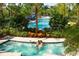 Relaxing resort-style pool and hot tub area with lush landscaping at 14501 Grove Resort Ave # 1507, Winter Garden, FL 34787