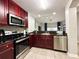 Modern kitchen with stainless steel appliances and dark wood cabinets at 14501 Grove Resort Ave # 1507, Winter Garden, FL 34787