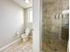 Small bathroom with toilet, shower, and tile flooring at 14501 Grove Resort Ave # 1507, Winter Garden, FL 34787