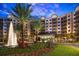 Apartment building with a fountain and lush landscaping at 14501 Grove Resort Ave # 1507, Winter Garden, FL 34787
