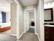 Bright hallway with wood-look flooring, leading to bedroom and bathroom at 14501 Grove Resort Ave # 1507, Winter Garden, FL 34787
