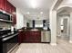 Modern kitchen with stainless steel appliances and dark wood cabinets at 14501 Grove Resort Ave # 1507, Winter Garden, FL 34787