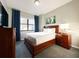 Bright bedroom with a wood bed frame, dresser and window at 14501 Grove Resort Ave # 1507, Winter Garden, FL 34787
