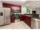 Modern kitchen with dark wood cabinets and stainless steel appliances at 14501 Grove Resort Ave # 1507, Winter Garden, FL 34787
