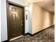 Apartment hallway with modern flooring and a dark brown door at 14501 Grove Resort Ave # 1507, Winter Garden, FL 34787