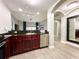 Modern kitchen with stainless steel appliances and dark wood cabinets at 14501 Grove Resort Ave # 1507, Winter Garden, FL 34787