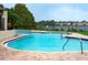 Inviting community pool with a lake view and surrounding lawn at 200 Afton Sq # 107, Altamonte Springs, FL 32714