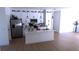 Modern kitchen with white cabinets, island, and stainless steel appliances at 13356 Sw 64Th Street Rd, Ocala, FL 34482