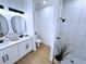 Modern bathroom with double vanity, oval mirrors, and a walk-in shower at 13356 Sw 64Th Street Rd, Ocala, FL 34482