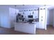Modern white kitchen with island and stainless steel appliances at 13356 Sw 64Th Street Rd, Ocala, FL 34482
