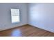 Bright bedroom with hardwood floors and a window with blinds at 13356 Sw 64Th Street Rd, Ocala, FL 34482