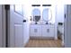 Modern bathroom with double vanity, oval mirrors, and a walk-in shower at 13356 Sw 64Th Street Rd, Ocala, FL 34482