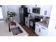 Modern white kitchen with stainless steel appliances and island at 13356 Sw 64Th Street Rd, Ocala, FL 34482