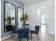 Bright dining area with glass table, four chairs, and view to entryway at 1502 Isleta Loop, Kissimmee, FL 34741