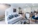 Open living room showcasing a comfortable sofa, kitchen island, and staircase at 1502 Isleta Loop, Kissimmee, FL 34741