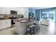Open concept kitchen with island, stainless steel appliances, and granite countertops at 1502 Isleta Loop, Kissimmee, FL 34741