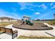 Community playground with playset and benches near a lake at 1502 Isleta Loop, Kissimmee, FL 34741