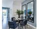 Modern dining area with glass table and four blue chairs at 1502 Isleta Loop, Kissimmee, FL 34741