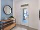 Bright and airy entryway with modern console table and large mirror at 1502 Isleta Loop, Kissimmee, FL 34741