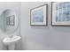 Clean powder room with pedestal sink and framed wall art at 1502 Isleta Loop, Kissimmee, FL 34741
