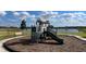 Community playground with playset near a lake at 1502 Isleta Loop, Kissimmee, FL 34741