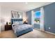 Spacious bedroom with blue upholstered bed and window at 1502 Isleta Loop, Kissimmee, FL 34741