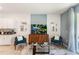 Living area with two teal armchairs, a coffee table and TV at 1502 Isleta Loop, Kissimmee, FL 34741