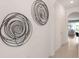Elegant hallway featuring modern wall art and tile flooring at 1502 Isleta Loop, Kissimmee, FL 34741