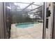 Relaxing screened-in pool area with a view of the backyard at 1379 Hampstead Ter, Oviedo, FL 32765