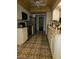 Galley kitchen with white cabinets, patterned tile floor, and stainless steel appliances at 7104 Scruboak Ln, Orlando, FL 32818