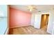 Bedroom with pink accent wall and carpet flooring at 301 Primrose Dr, Davenport, FL 33837