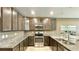 L-shaped kitchen with dark brown cabinets and granite countertops at 301 Primrose Dr, Davenport, FL 33837