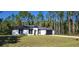 Single-story home with a gray roof and landscaping at 4115 Swamp Deer Rd, New Smyrna Beach, FL 32168