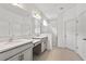 Modern bathroom with double vanity, shower, and neutral tile at 890 Terrapin Dr, Debary, FL 32713