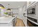 Modern kitchen with white cabinets, stainless steel appliances, and gold accents at 890 Terrapin Dr, Debary, FL 32713