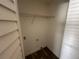 Laundry closet with wire shelving and vinyl flooring at 641 Bayport Dr, Kissimmee, FL 34758