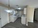 Updated kitchen with white cabinets, light countertops, and gray flooring at 641 Bayport Dr, Kissimmee, FL 34758