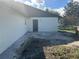 Rear exterior view with concrete patio at 641 Bayport Dr, Kissimmee, FL 34758